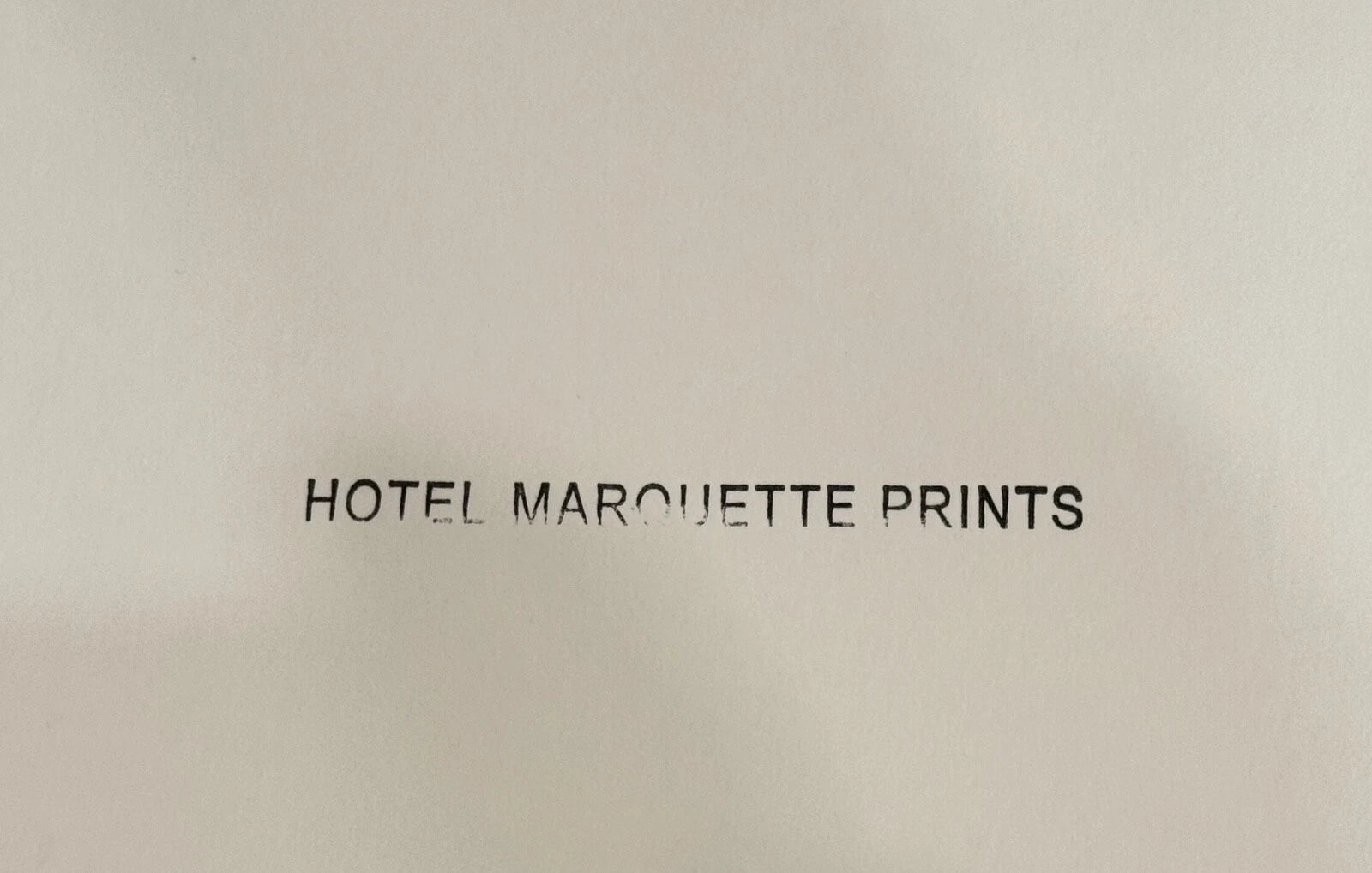 Text 'HOTEL MARQUETTE PRINTS' on a beige background