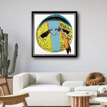 Framed abstract artwork on a wall above a white sofa in a living room.