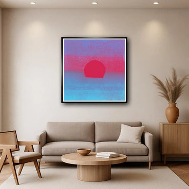 Modern living room with a gray sofa, wooden coffee table, and abstract art on the wall.