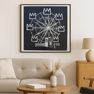 Framed artwork of a Ferris wheel with crowns above it in a living room . setting. BANKSY BANKSQUAIT