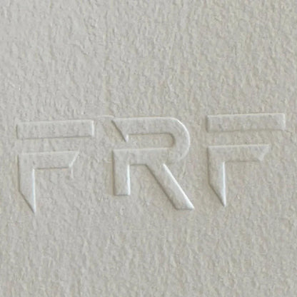 Textured white surface with embossed letters 'FRF' design