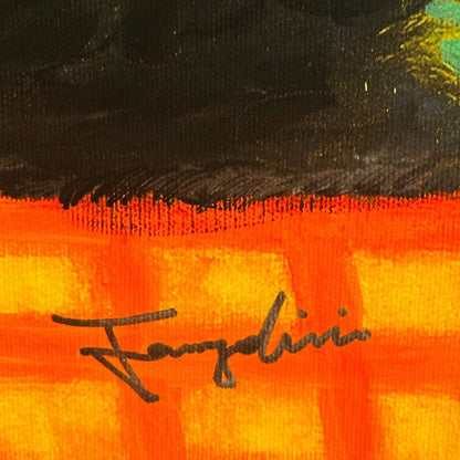Close-up of a colorful fabric with a signature on an orange and black background