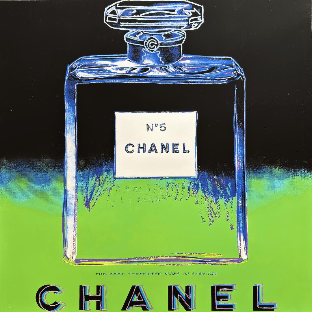 Chanel No. 5 perfume bottle with colorful design on a black and green background