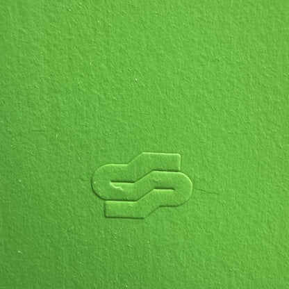 Green textured surface with a logo embossed in the center