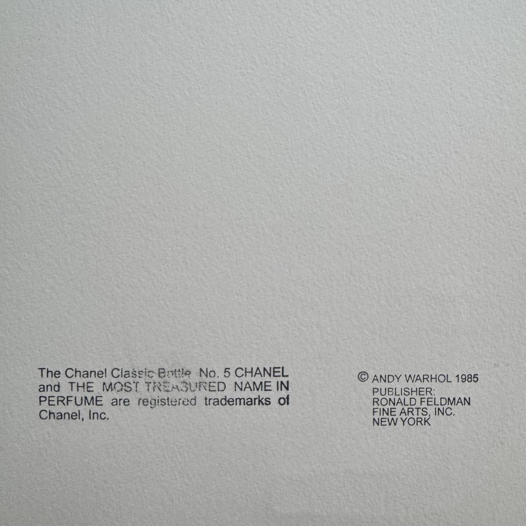 Gray background with black text and a copyright notice for Chanel and Andy Warhol.