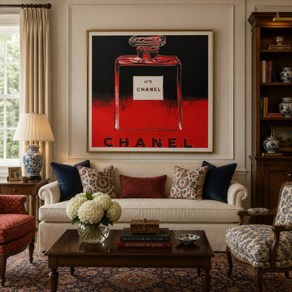 Living room with Chanel artwork on the wall, featuring a sofa with patterned cushions and a coffee table.