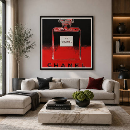 Modern living room with a Chanel perfume bottle artwork on the wall.