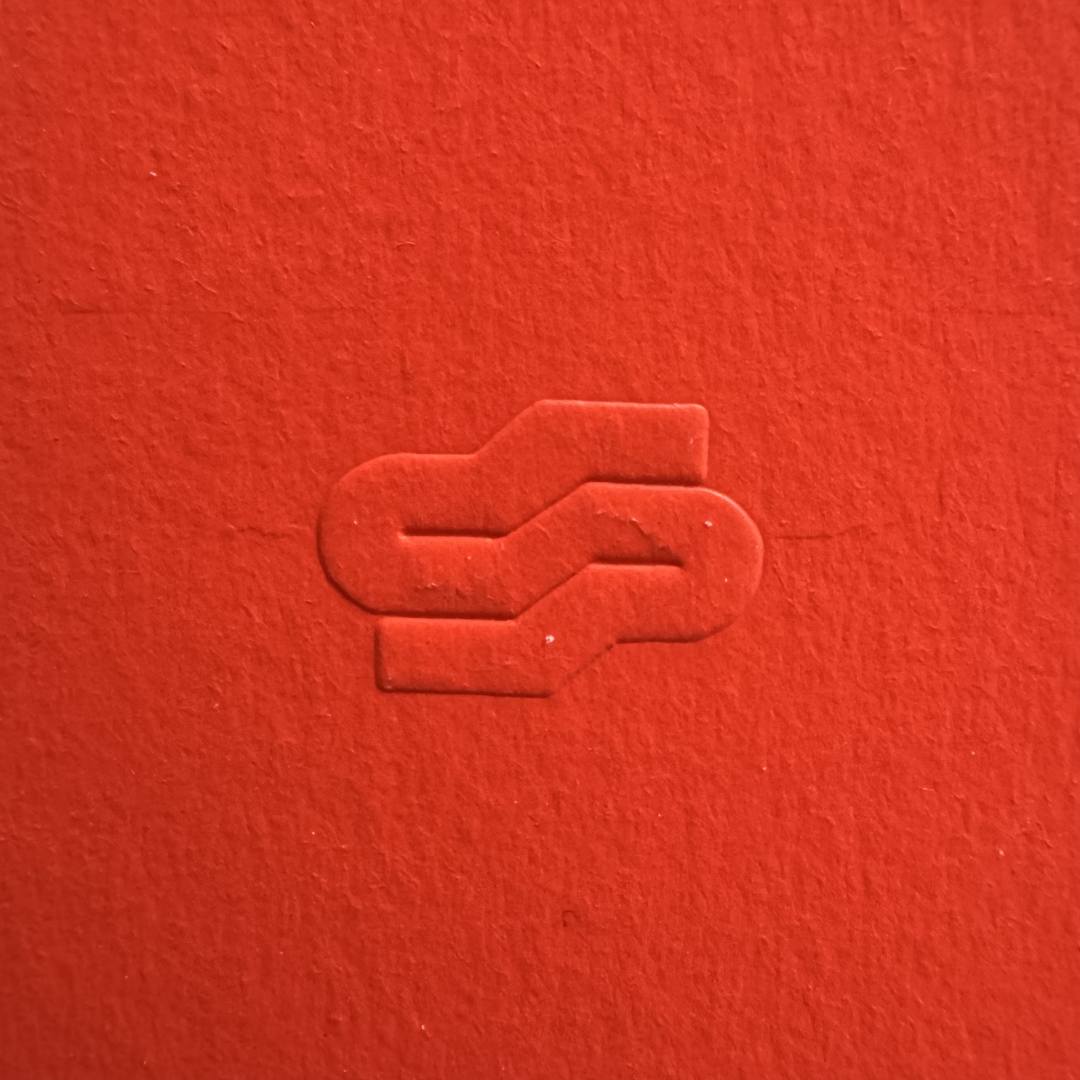 Red textured surface with a subtle embossed design