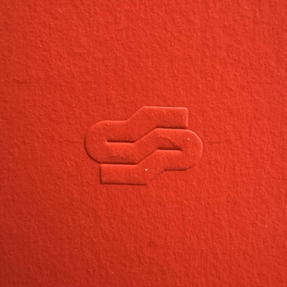 Red textured surface with a subtle embossed design