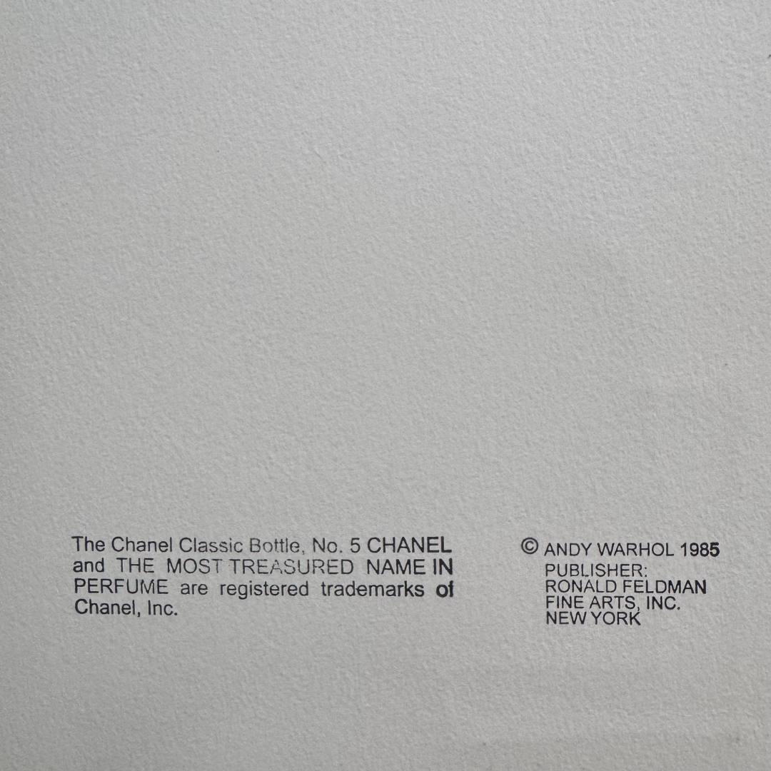 Gray background with black text crediting Chanel and Andy Warhol.