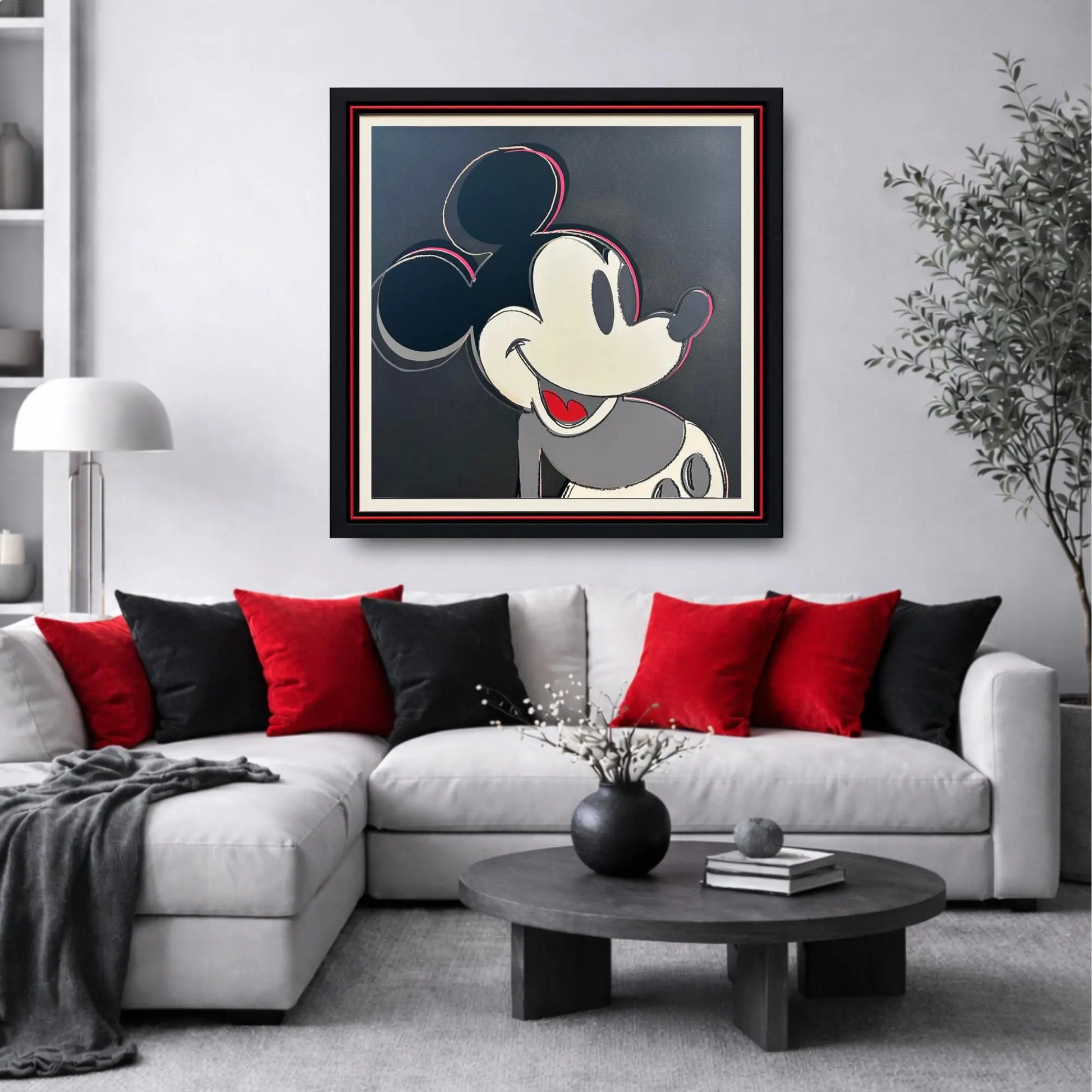 Living room with a framed picture of a cartoon character on the wall above a sofa.